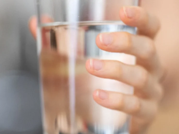 hand holding a glass of water